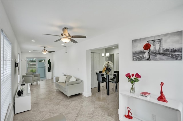 tiled living room with ceiling fan