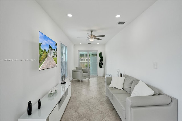 living room featuring ceiling fan and light tile patterned floors