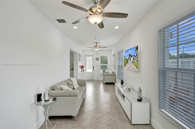 tiled living room featuring ceiling fan