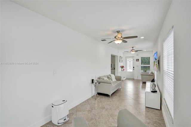 living room featuring ceiling fan and light tile patterned flooring