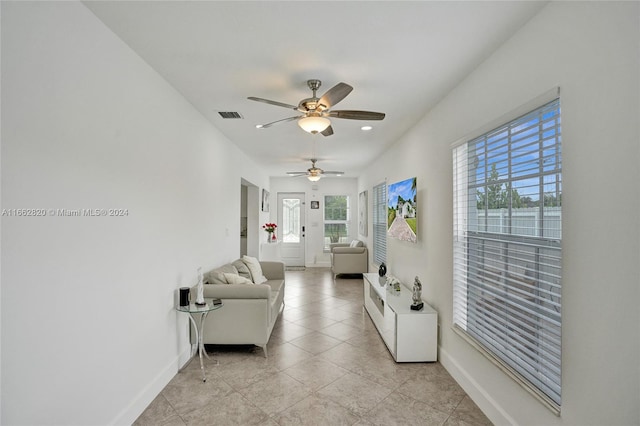 living room featuring ceiling fan and light tile patterned floors