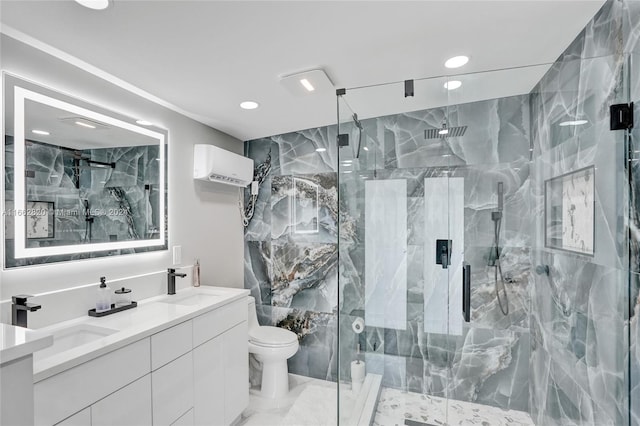 bathroom featuring a shower with door, vanity, and toilet