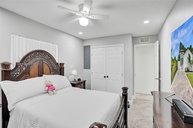 bedroom with electric panel, ceiling fan, and a closet