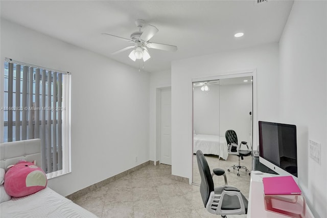 interior space with ceiling fan and a closet