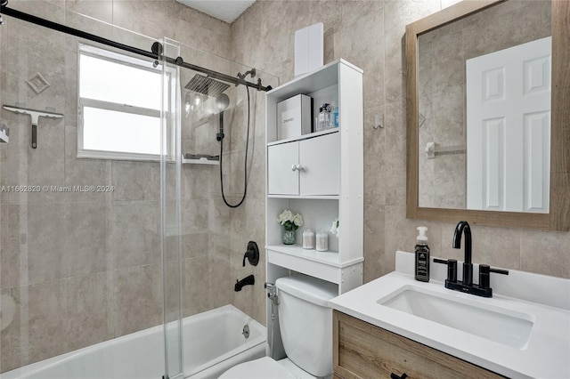 full bathroom featuring shower / bath combination with glass door, vanity, tile walls, and toilet