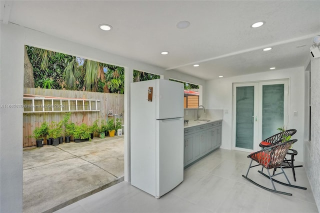 kitchen with sink, gray cabinets, and white refrigerator