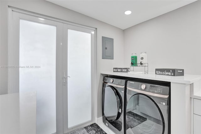 laundry room with electric panel and independent washer and dryer