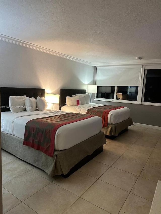 bedroom with a textured ceiling, light tile patterned flooring, and crown molding