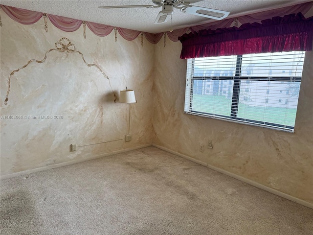 spare room with ceiling fan, carpet floors, and a textured ceiling