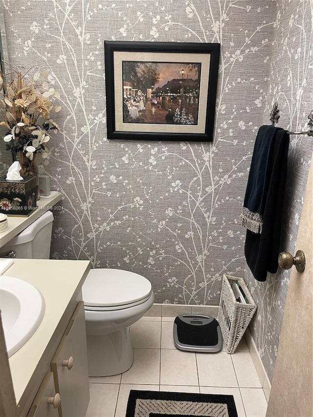 bathroom featuring tile patterned flooring, vanity, and toilet