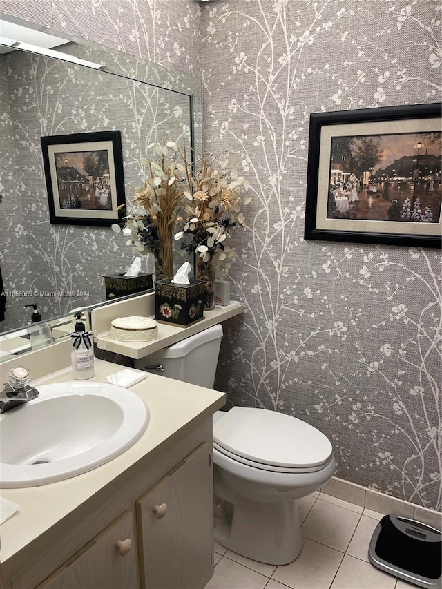 bathroom with tile patterned flooring, vanity, and toilet