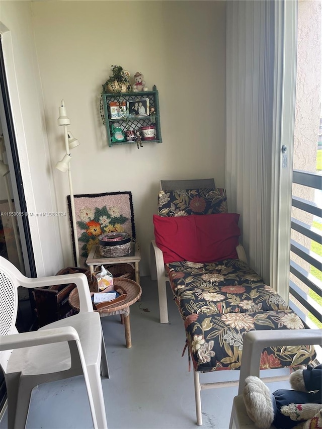 bedroom with concrete flooring and multiple windows