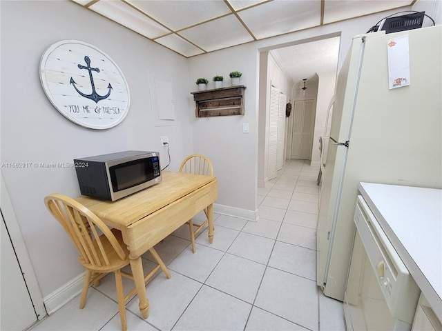 interior space with light tile patterned floors and white appliances