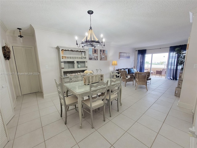 tiled dining space featuring an inviting chandelier, a textured ceiling, and crown molding