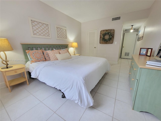 tiled bedroom featuring a closet