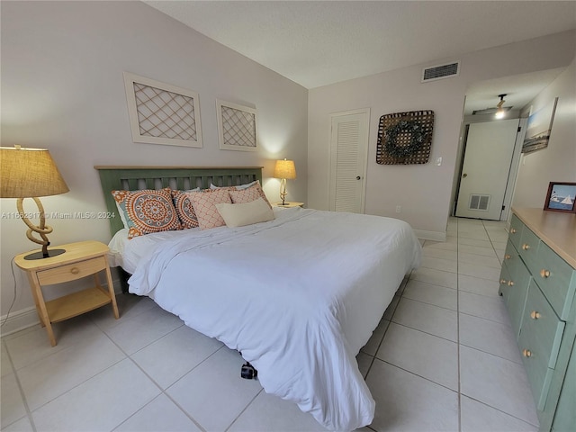 tiled bedroom with a closet