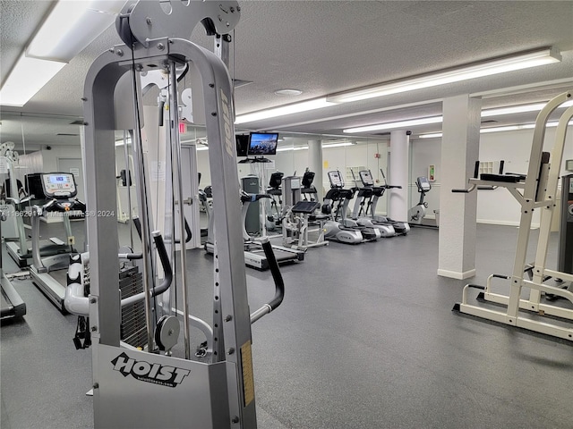 gym featuring a textured ceiling