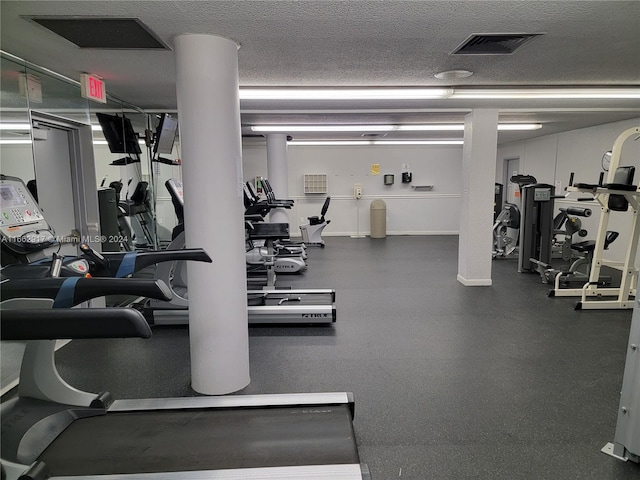 gym with a textured ceiling