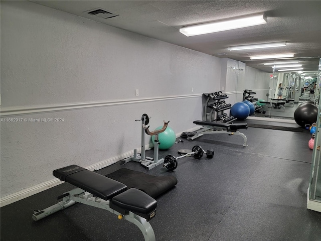 1980 S Ocean Dr Unit 2C, Hallandale Beach, FL 33009 - gym with a textured ceiling, oil tank, and a textured wall