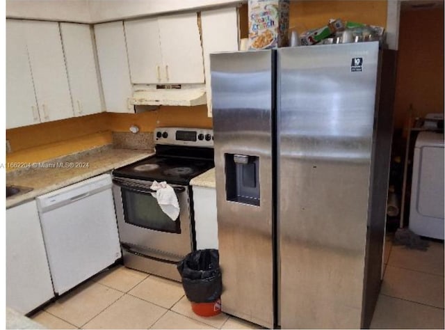 kitchen with white cabinets, light tile patterned flooring, stainless steel appliances, and range hood