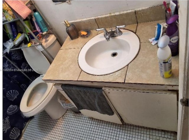 bathroom with vanity, tile patterned floors, and toilet