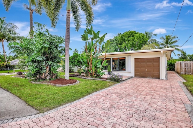 view of front facade with a front yard and a garage