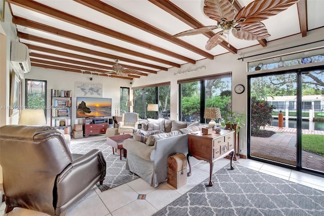 living room with ceiling fan, beamed ceiling, and a healthy amount of sunlight