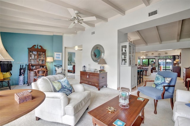 carpeted living room featuring ceiling fan and beam ceiling