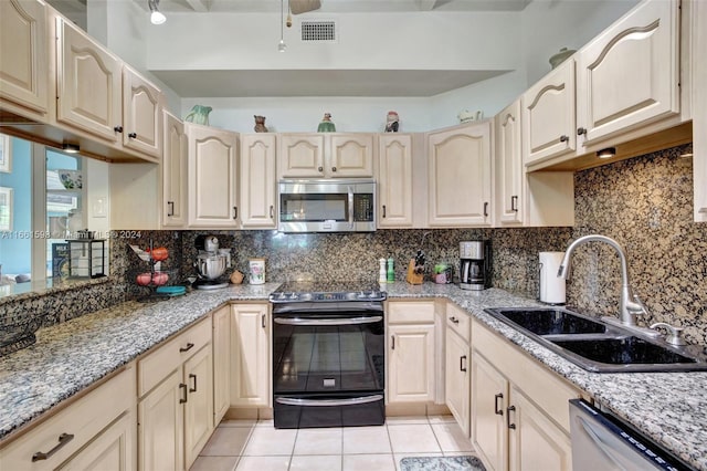 kitchen featuring sink, decorative backsplash, stainless steel appliances, light tile patterned floors, and light stone countertops