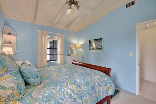 bedroom with lofted ceiling with beams, ceiling fan, and tile patterned floors