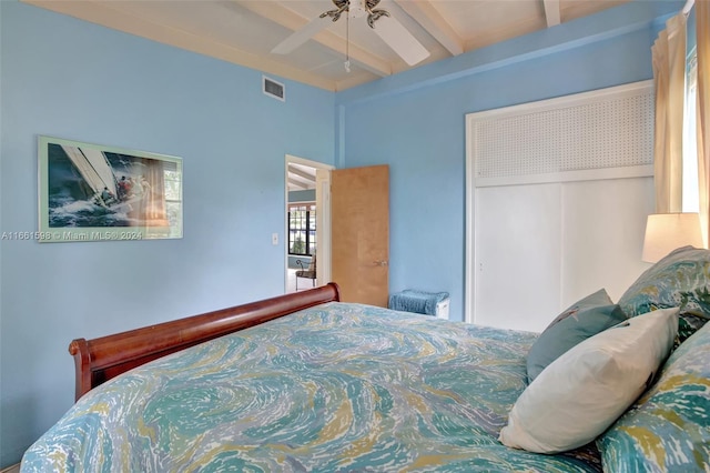 bedroom featuring ceiling fan, a closet, and beam ceiling