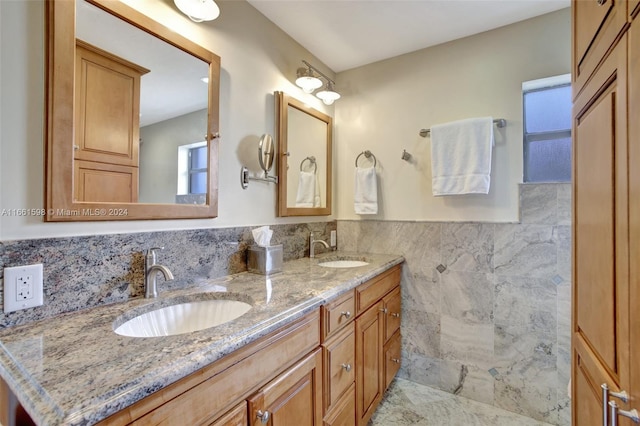 bathroom featuring vanity and tile walls