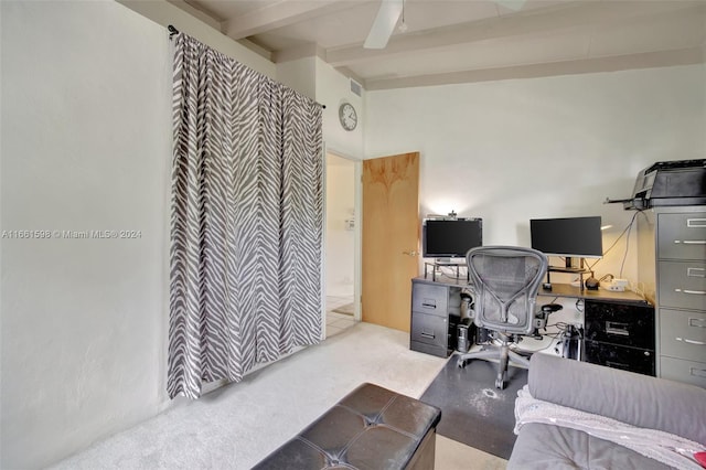 carpeted office space with ceiling fan and beamed ceiling