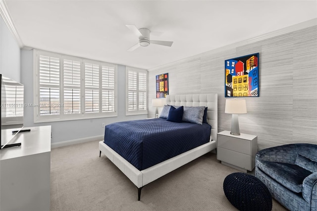 bedroom with light carpet, ceiling fan, and ornamental molding