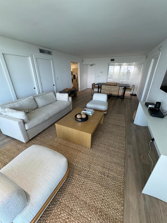 living room featuring dark wood-type flooring