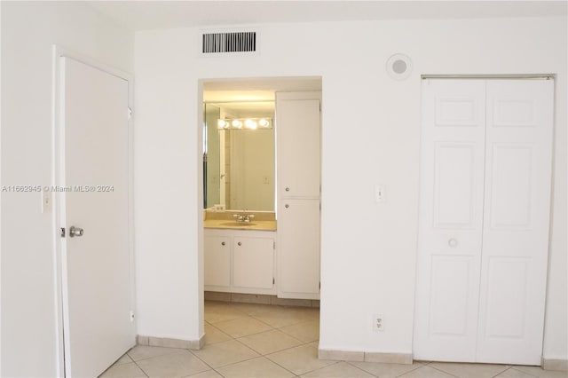 16919 N Bay Rd Unit 118, Sunny Isles Beach, FL 33160 - unfurnished bedroom featuring light tile patterned floors, a closet, and connected bathroom