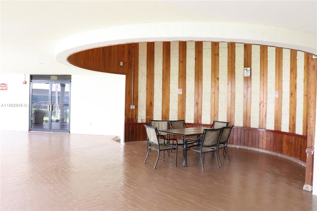 dining room featuring wood walls