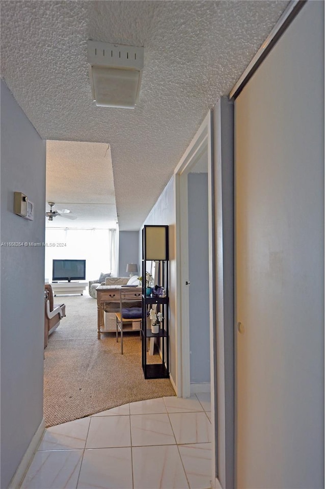 200 172nd St Unit 306, Sunny Isles Beach, FL 33160 - hallway featuring carpet floors, a textured ceiling, and baseboards