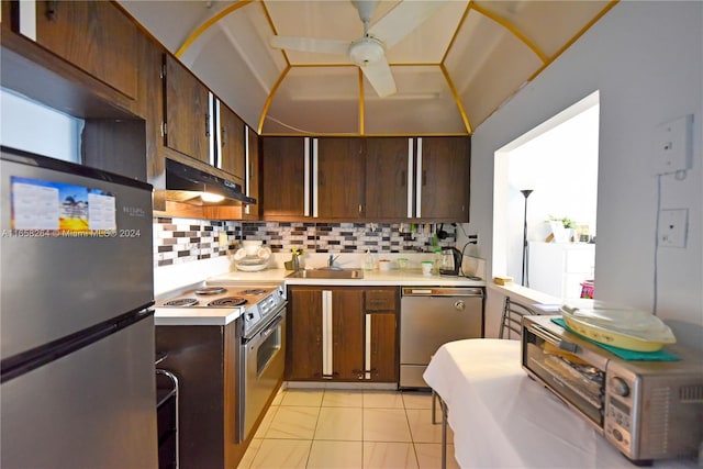 kitchen with ceiling fan, light tile patterned floors, sink, appliances with stainless steel finishes, and decorative backsplash