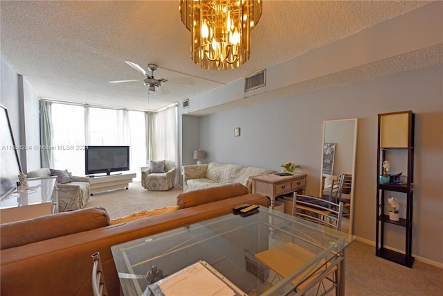 living room featuring a textured ceiling, ceiling fan with notable chandelier, and carpet