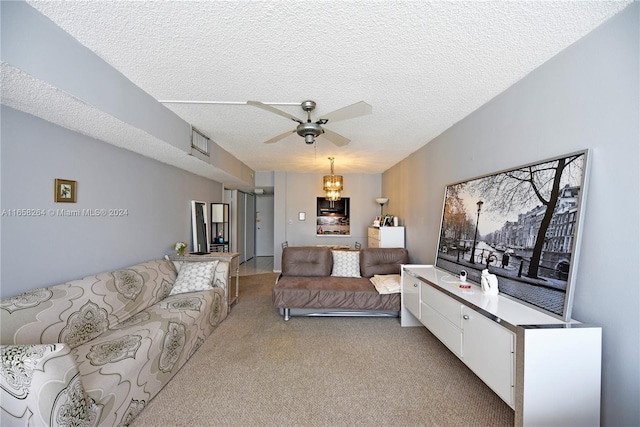 carpeted living room featuring a textured ceiling and ceiling fan