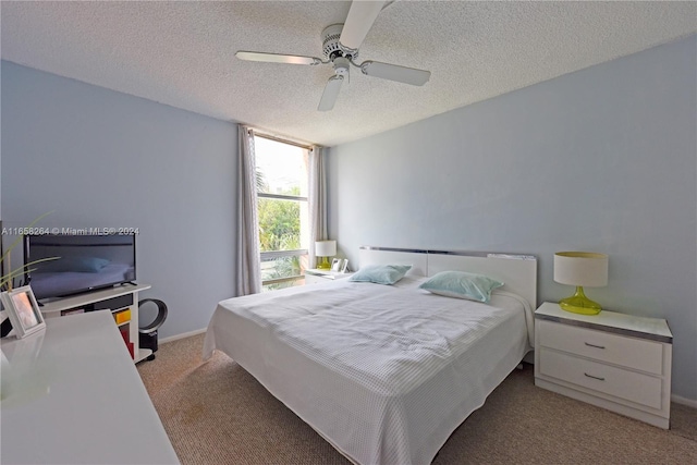 bedroom featuring ceiling fan, a textured ceiling, and light carpet