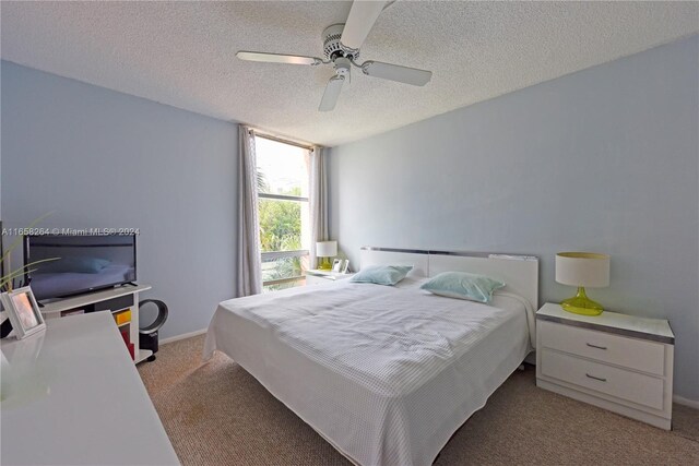 200 172nd St Unit 306, Sunny Isles Beach, FL 33160 - carpeted bedroom with a textured ceiling and ceiling fan