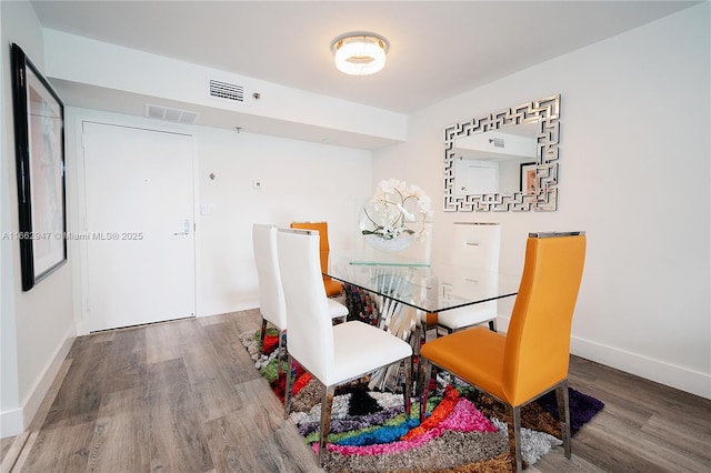 dining space with hardwood / wood-style flooring