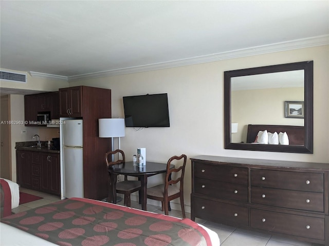 tiled bedroom with crown molding, sink, and white fridge