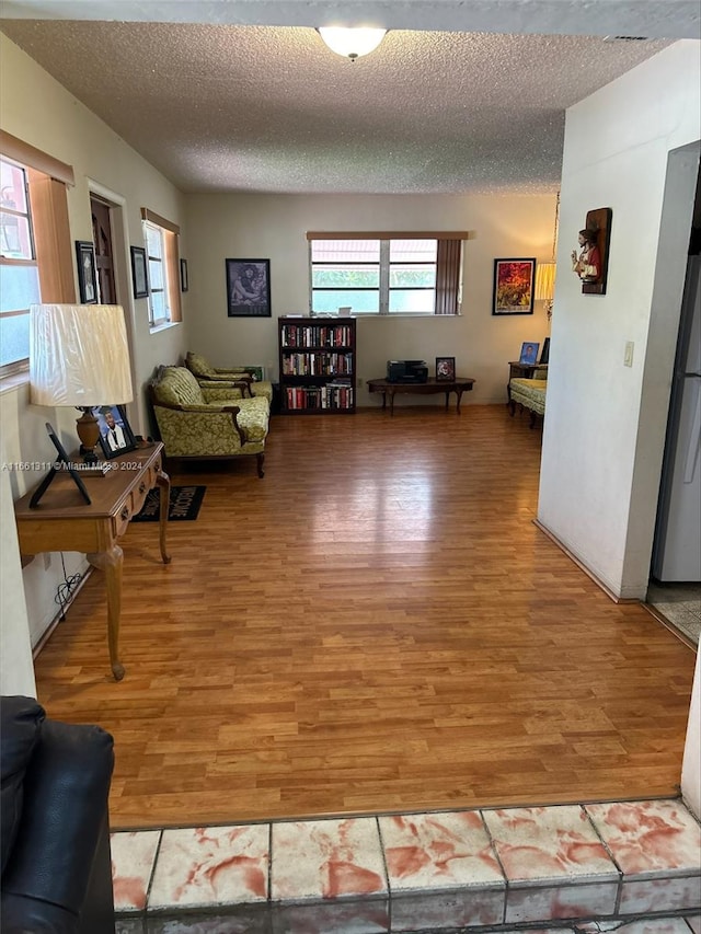 living area featuring hardwood / wood-style flooring and a healthy amount of sunlight