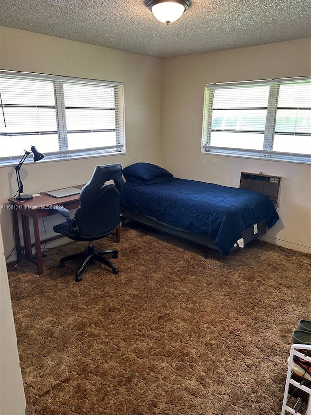 carpeted bedroom with a textured ceiling