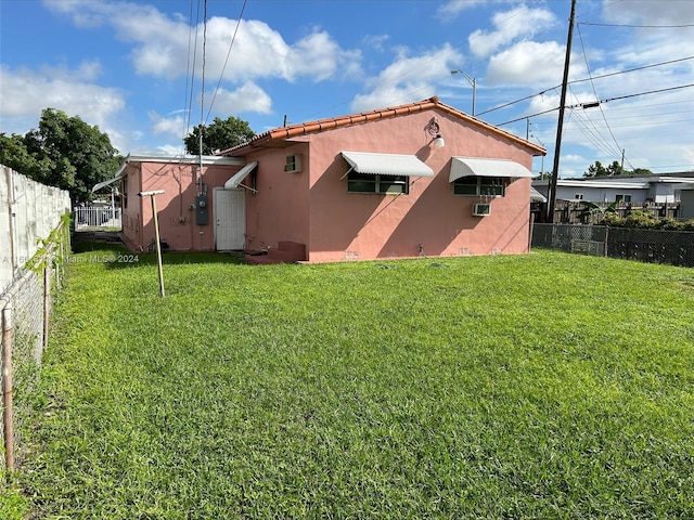 back of property featuring a lawn