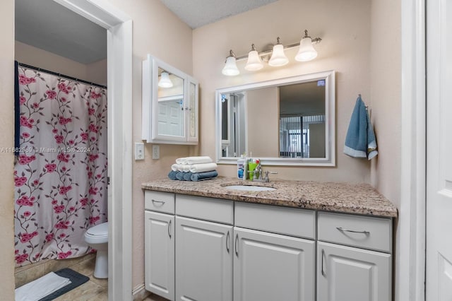 bathroom with vanity, toilet, and tile patterned floors