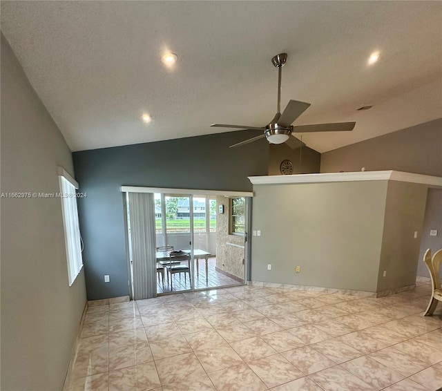 spare room featuring ceiling fan, a textured ceiling, and lofted ceiling